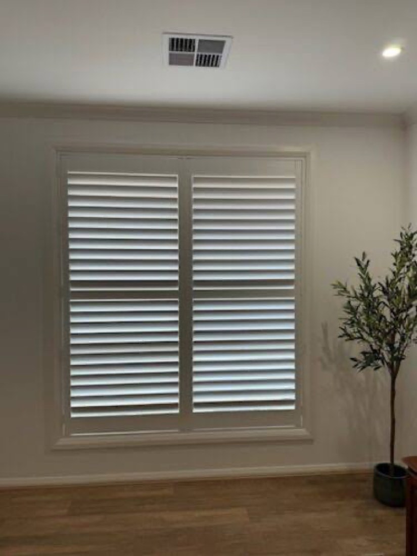White plantation shutters installed in a completed home